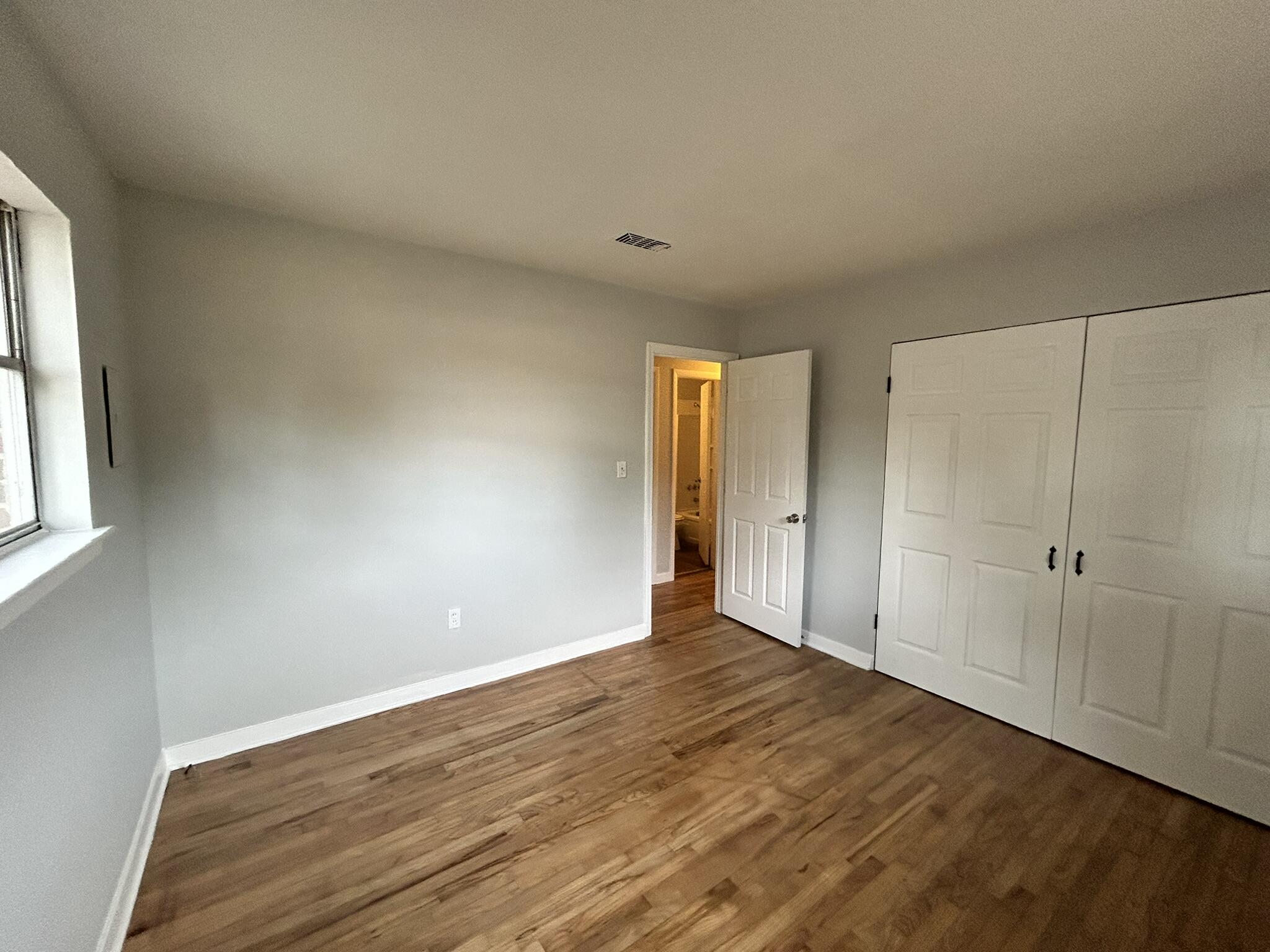 553 Purl Adams Avenue Crestview, FL 32539 - Photo 13 of 13 a view of an empty room with wooden floor and a window