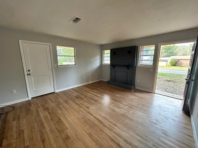 a kitchen with granite countertop a sink a stove a refrigerator and cabinets