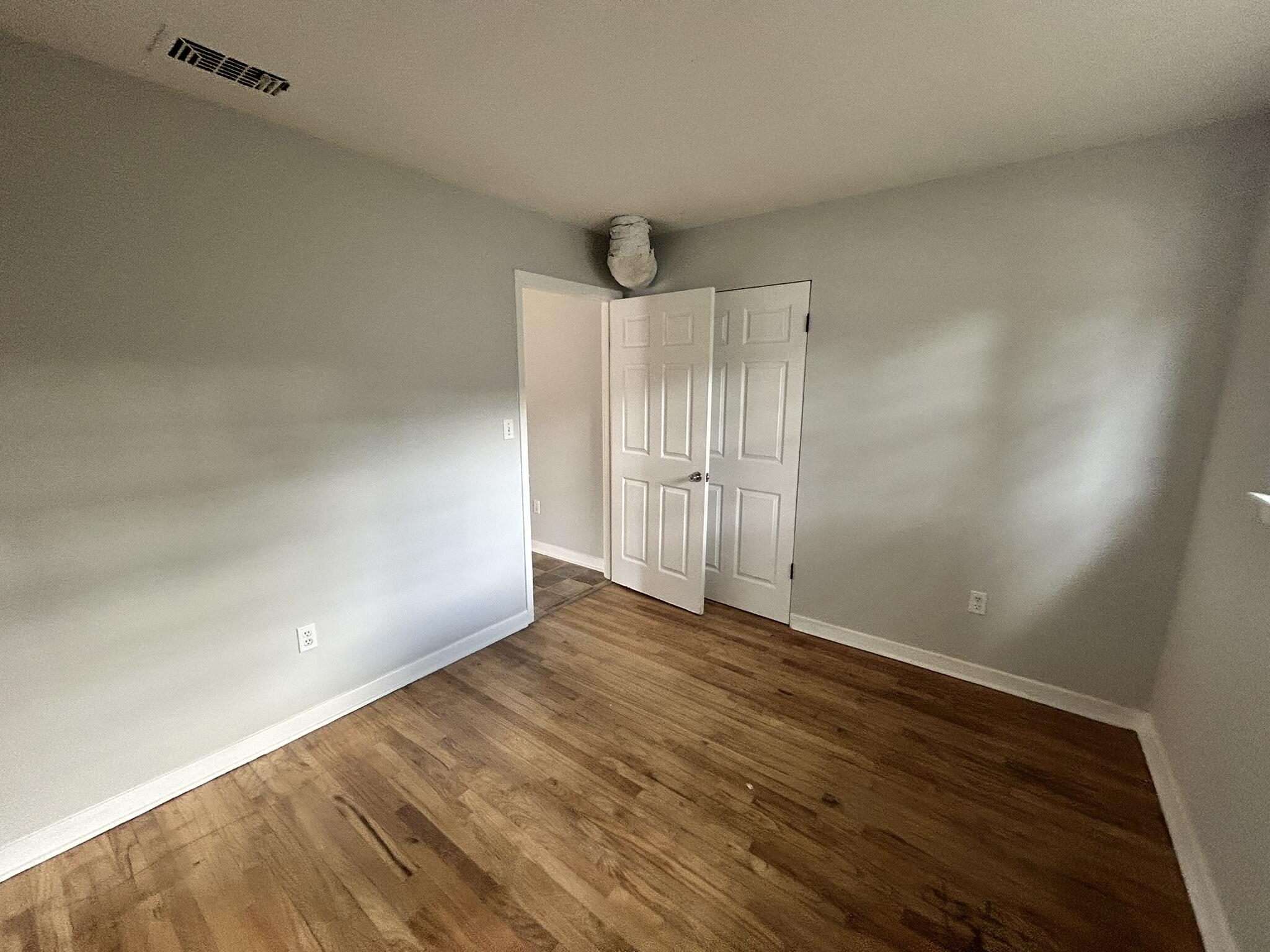 553 Purl Adams Avenue Crestview, FL 32539 - Photo 6 of 13 a view of an empty room with wooden floor and a window