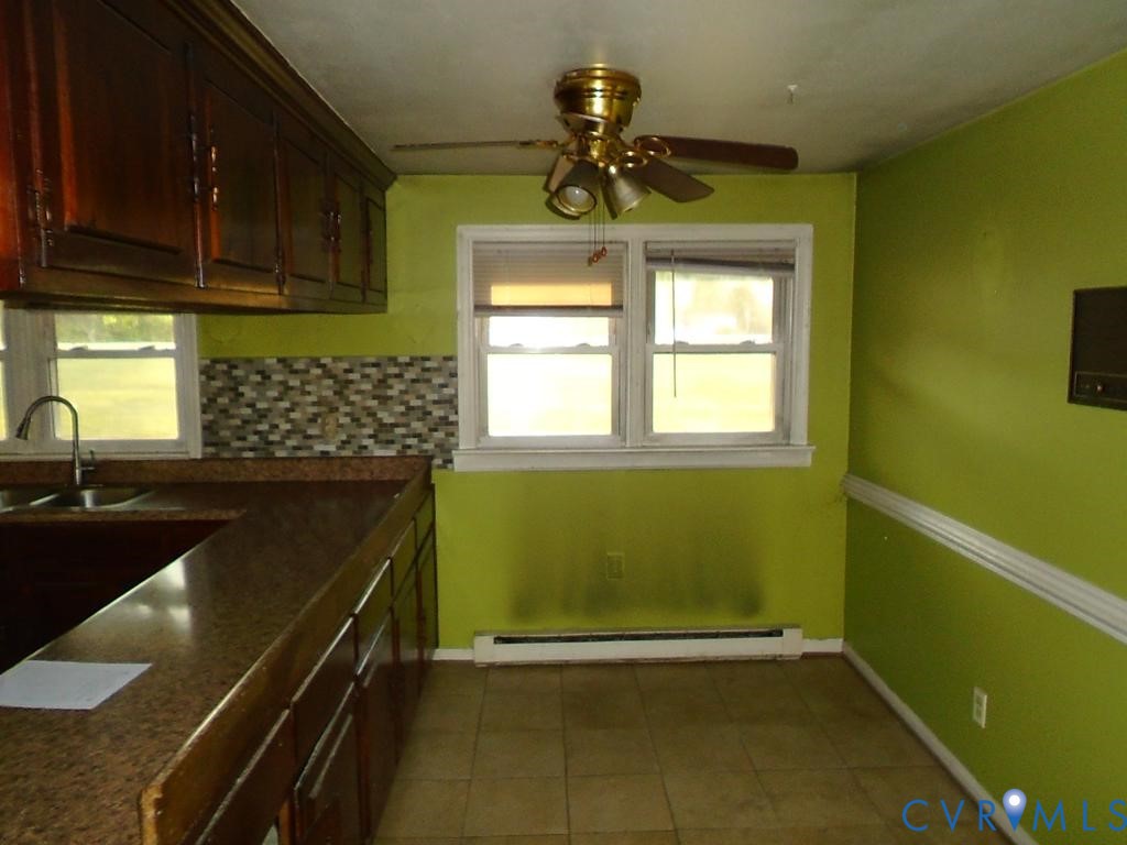 16203 West Patrick Henry Road Montpelier, VA 23192 - Photo 17 of 23 Kitchen area featuring rich wood-finish cabinetry,