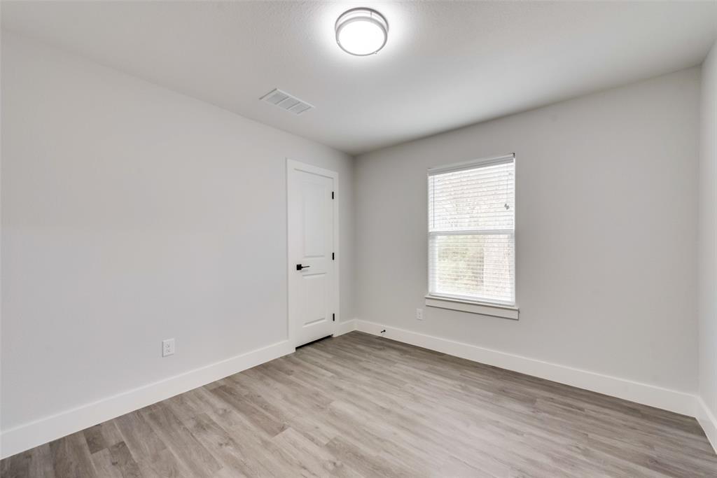 420 East 5th Street Bonham, TX 75418 - Photo 15 of 16 an empty room with wooden floor and windows