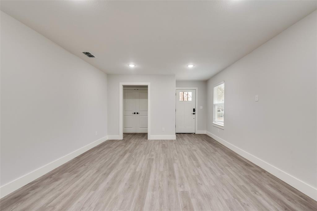 420 East 5th Street Bonham, TX 75418 - Photo 2 of 16 an empty room with wooden floor and window