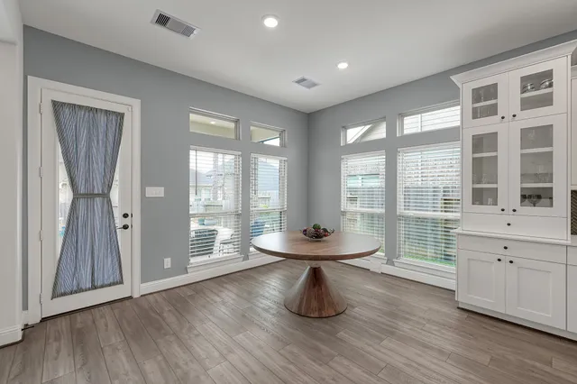 a room with wooden floor and furniture