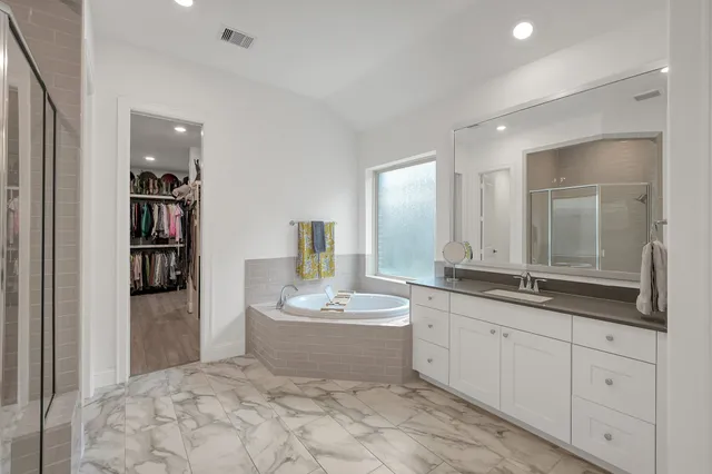 a spacious bathroom with a double vanity sink and a mirror