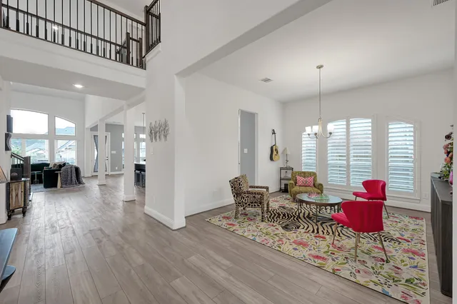 a living room with furniture and wooden floor