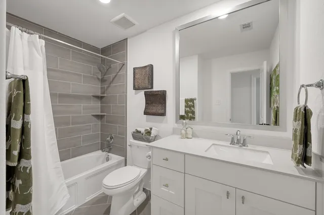 a bathroom with a sink toilet tub and shower