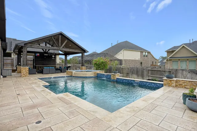 a view of a patio with swimming pool table and chairs