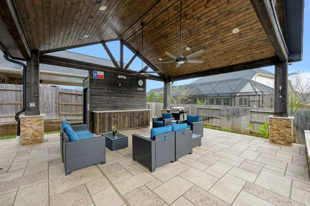 a view of a patio with couches and table under an umbrella