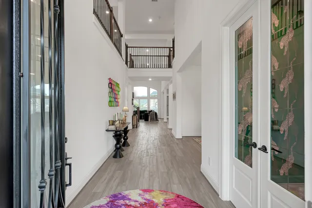 a hallway with a wooden floor and entryway