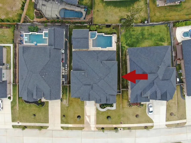 an aerial view of residential houses with outdoor space