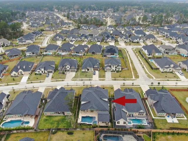 an aerial view of residential houses with outdoor space