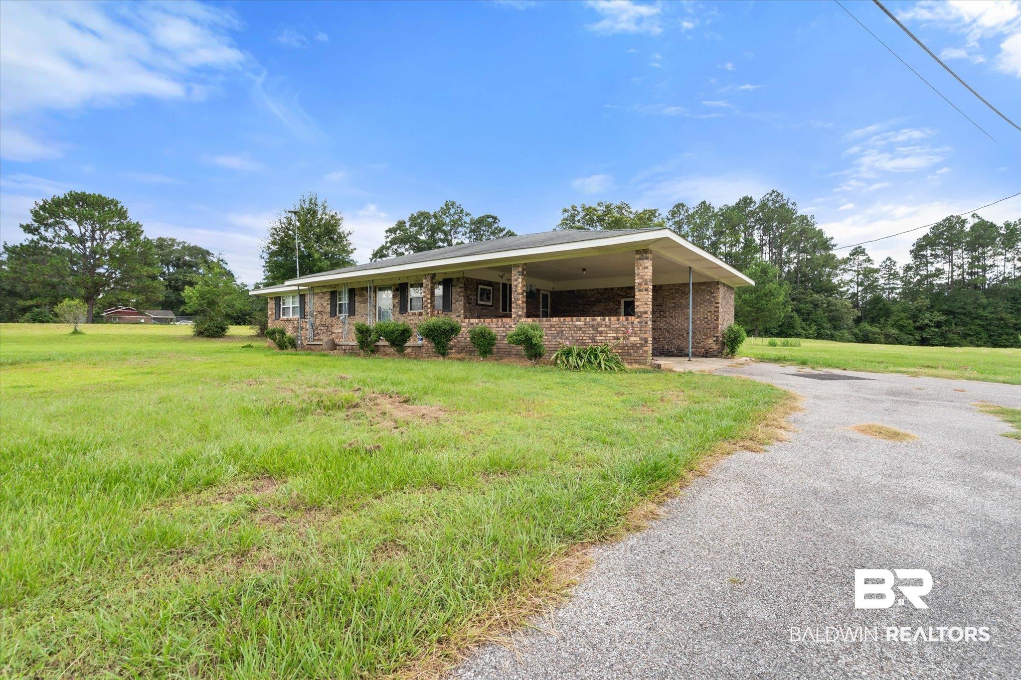 11601 Lott Road Chunchula, AL 36521 - Photo 15 of 34 Single story home with driveway, a front lawn, an attached carport, and brick siding