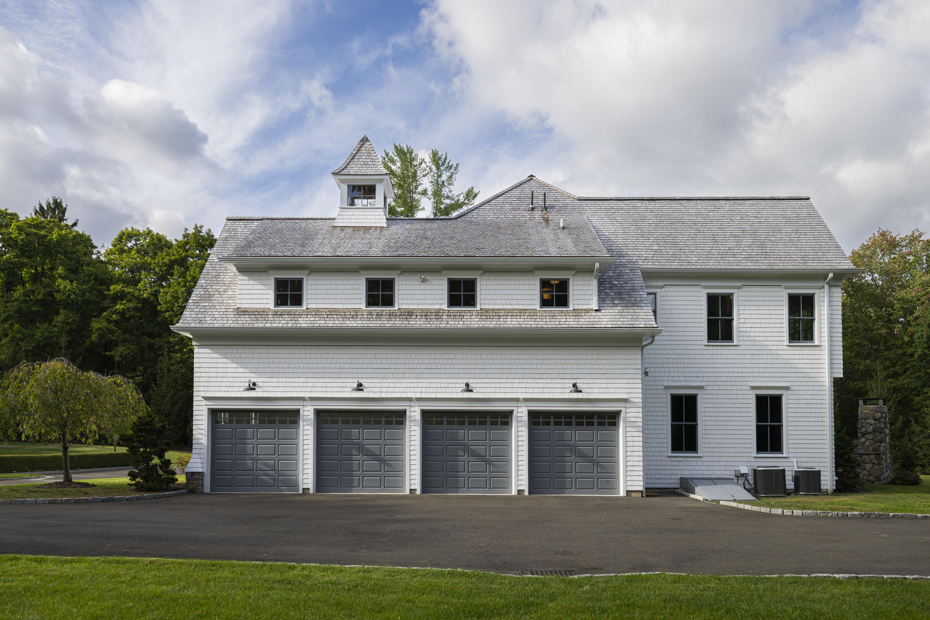 375 West Road New Canaan, CT 06840 - Photo 24 of 26 a front view of a house with a garden and plants