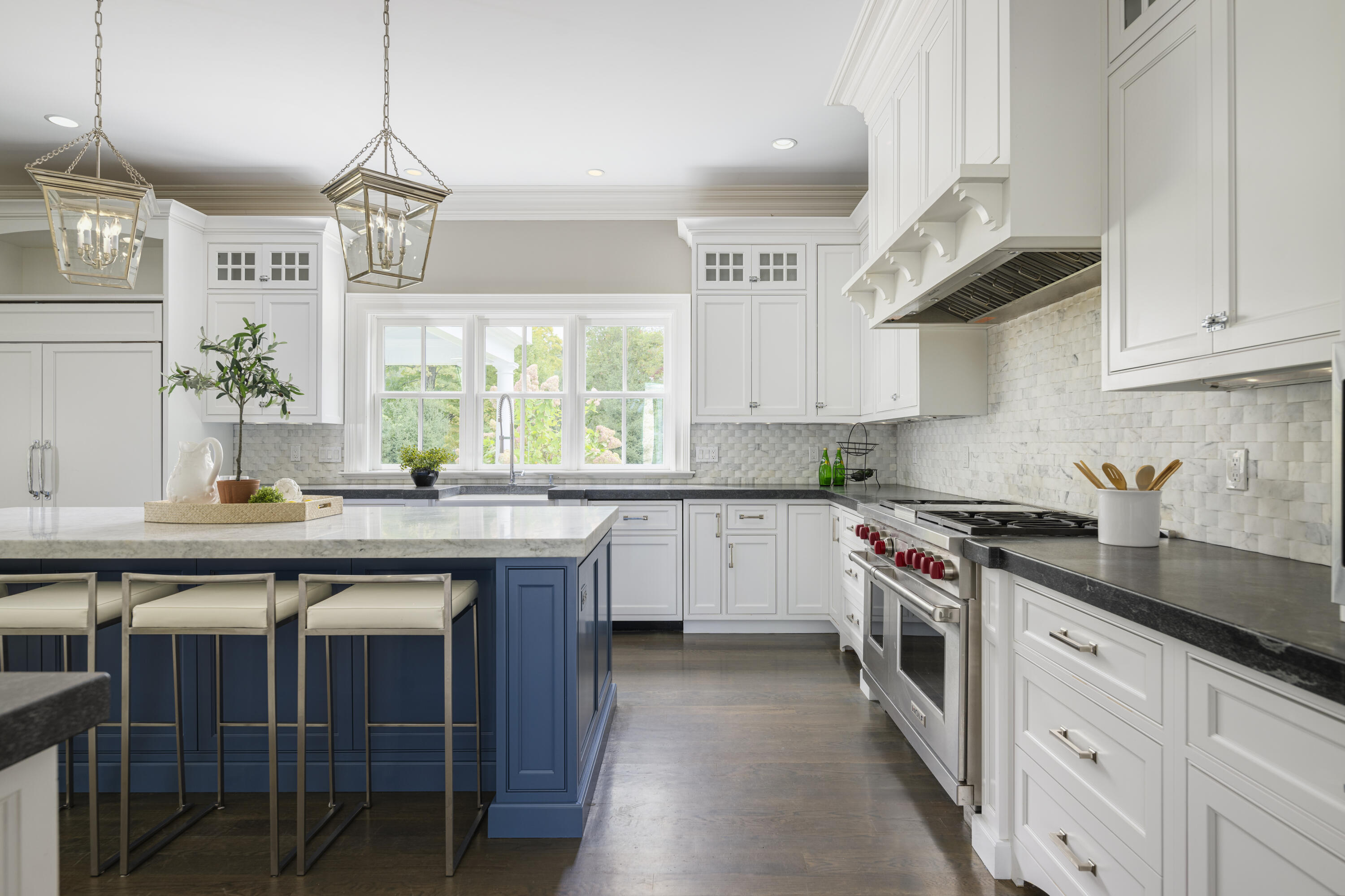 375 West Road New Canaan, CT 06840 - Photo 7 of 26 a kitchen with stainless steel appliances a stove a sink dishwasher and white cabinets with wooden floor