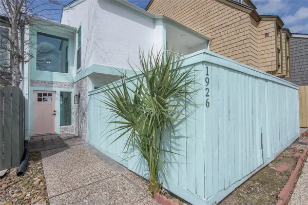 a view of a palm tree in front of a house