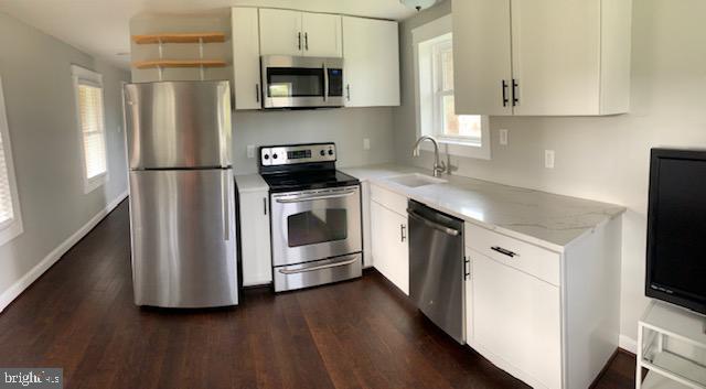 18812 Harmony Church Road Leesburg, VA 20175 - Photo 5 of 6 a kitchen with stainless steel appliances a stove a sink and a microwave