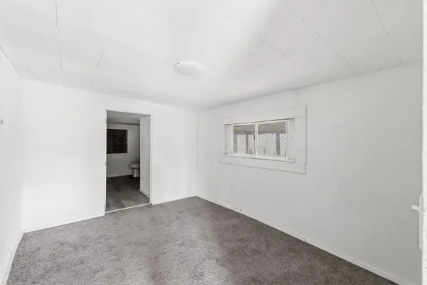 a view of a room with a hallway and closet
