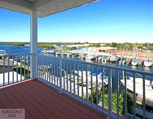 3901 Floramar Terrace New Port Richey, FL 34652 - Photo 1 of 1 Exterior Front - Balcony off Master Bedroom with water views. That s a 42 yacht tied up at the floating dock.