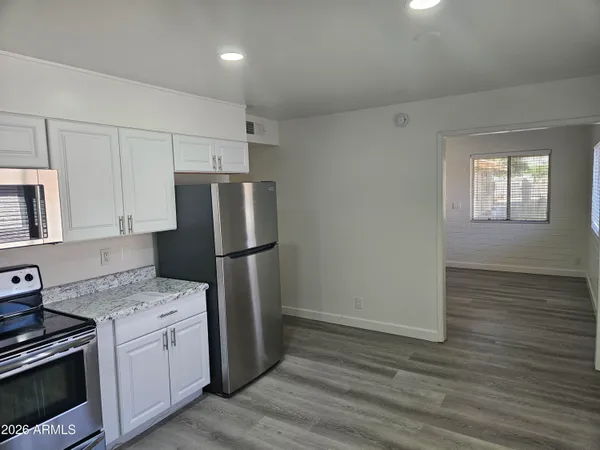 a kitchen with a refrigerator sink and stove