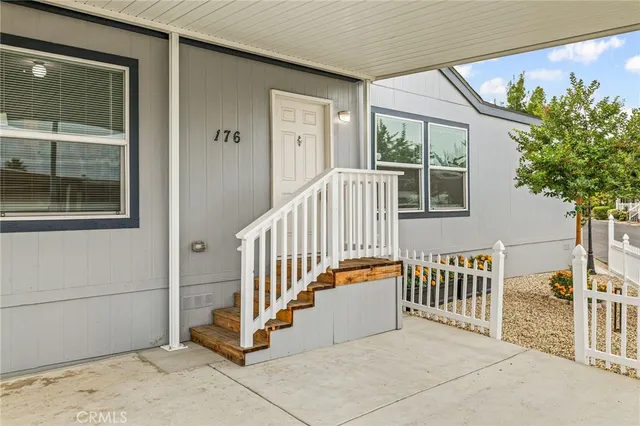 a view of a porch with wooden floor and fence