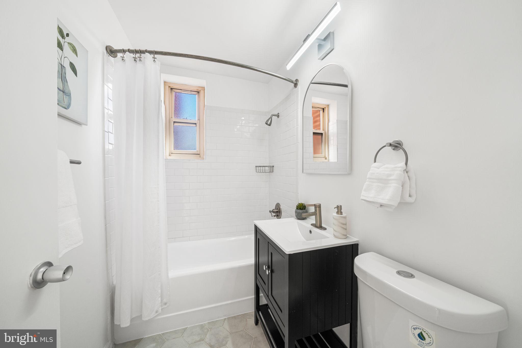 4000 Tunlaw Road Northwest, Unit 811 Washington, DC 20007 - Photo 17 of 33 Light-filled bathroom with updated finishes