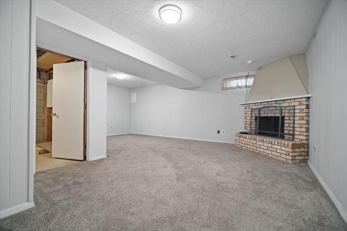 1707 King Drive, Unit D Normal, IL 61761 - Photo 16 of 24 an empty room with fireplace and a chandelier