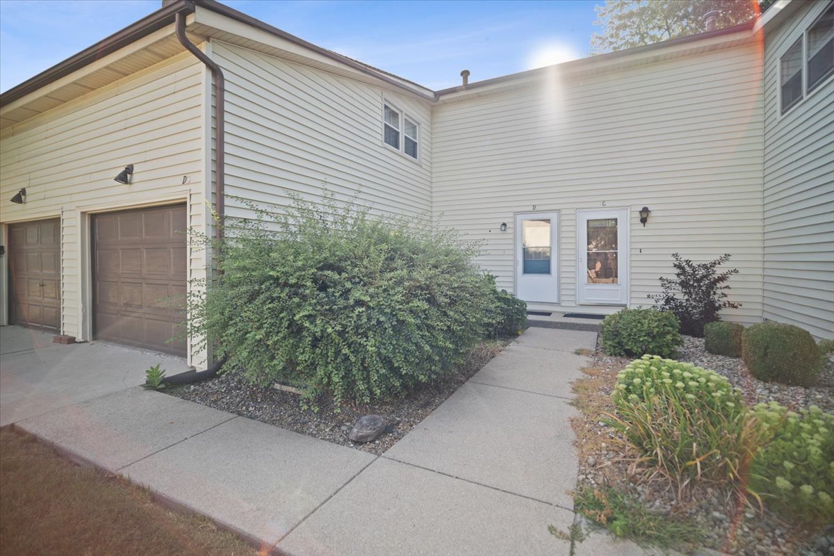 1707 King Drive, Unit D Normal, IL 61761 - Photo 2 of 24 a backyard of a house with potted plants