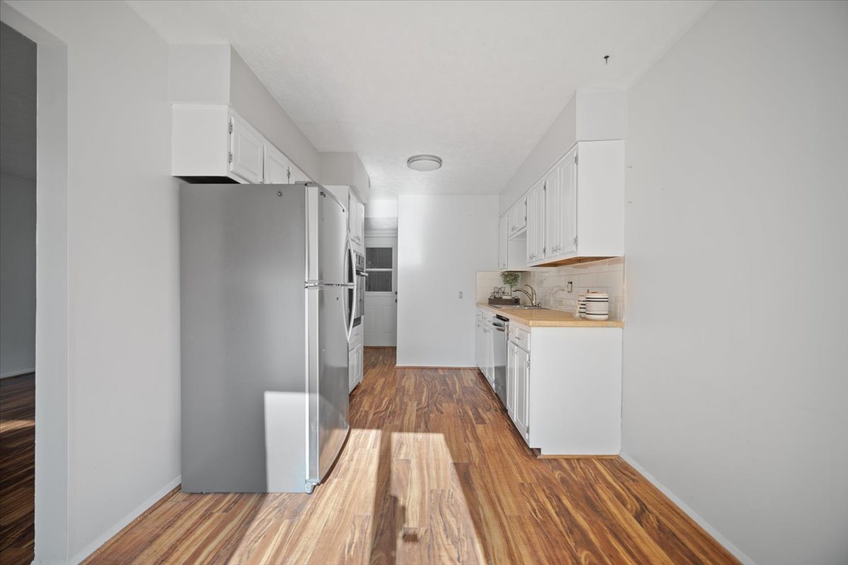 1707 King Drive, Unit D Normal, IL 61761 - Photo 9 of 24 a kitchen with a refrigerator and wooden floor