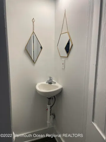 a bathroom with a sink a mirror and a toilet