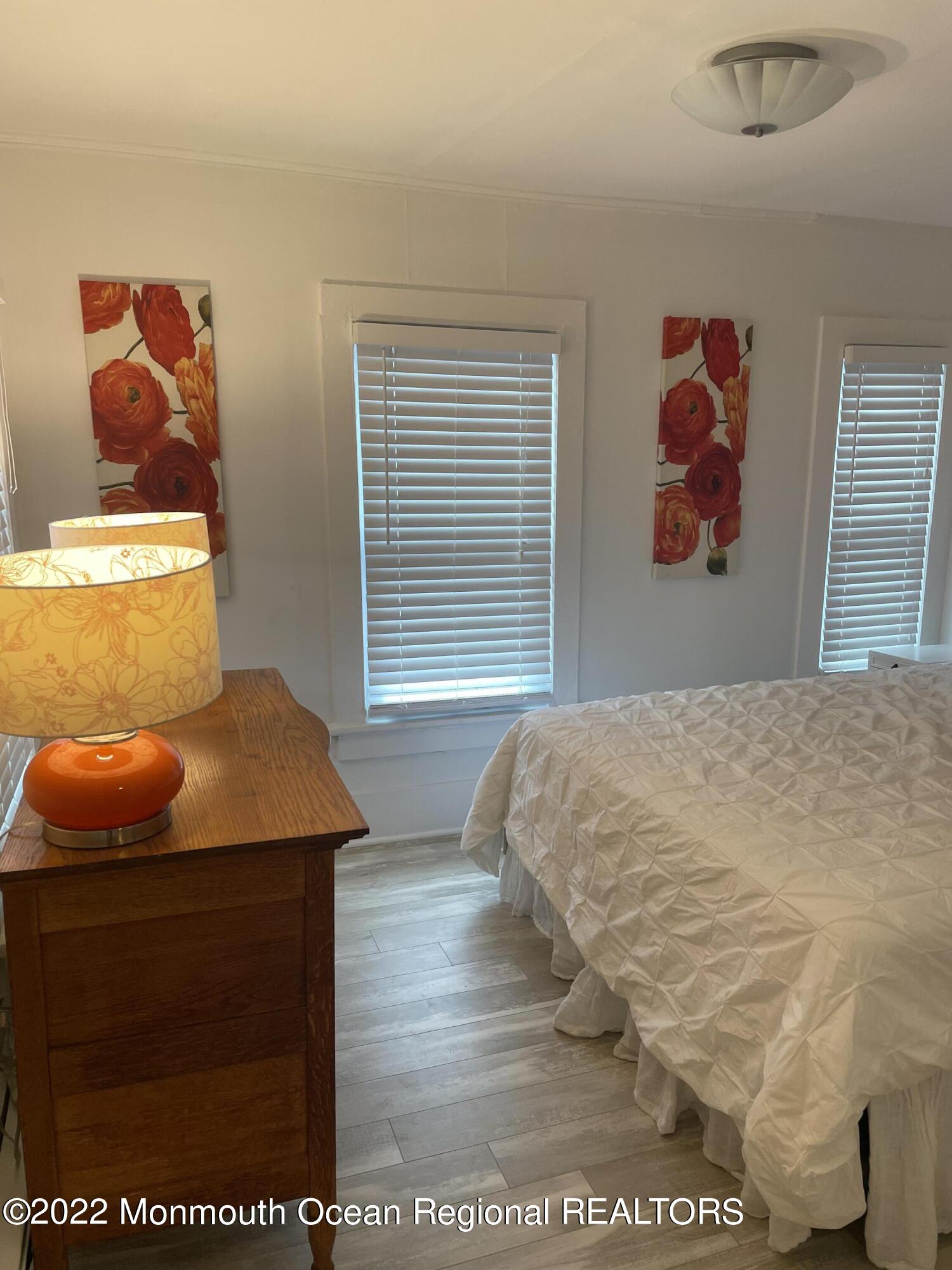 143 Mt Hermon Way, Unit 1/2 Ocean Grove, NJ 07756 - Photo 14 of 26 a bed sitting in a bedroom next to a window