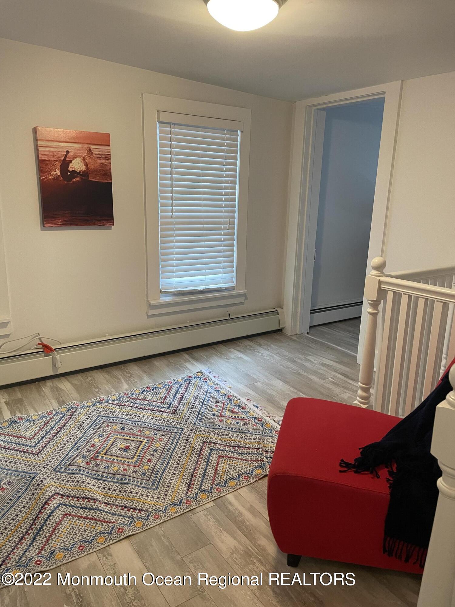 143 Mt Hermon Way, Unit 1/2 Ocean Grove, NJ 07756 - Photo 16 of 26 a view of room with window and wooden floor