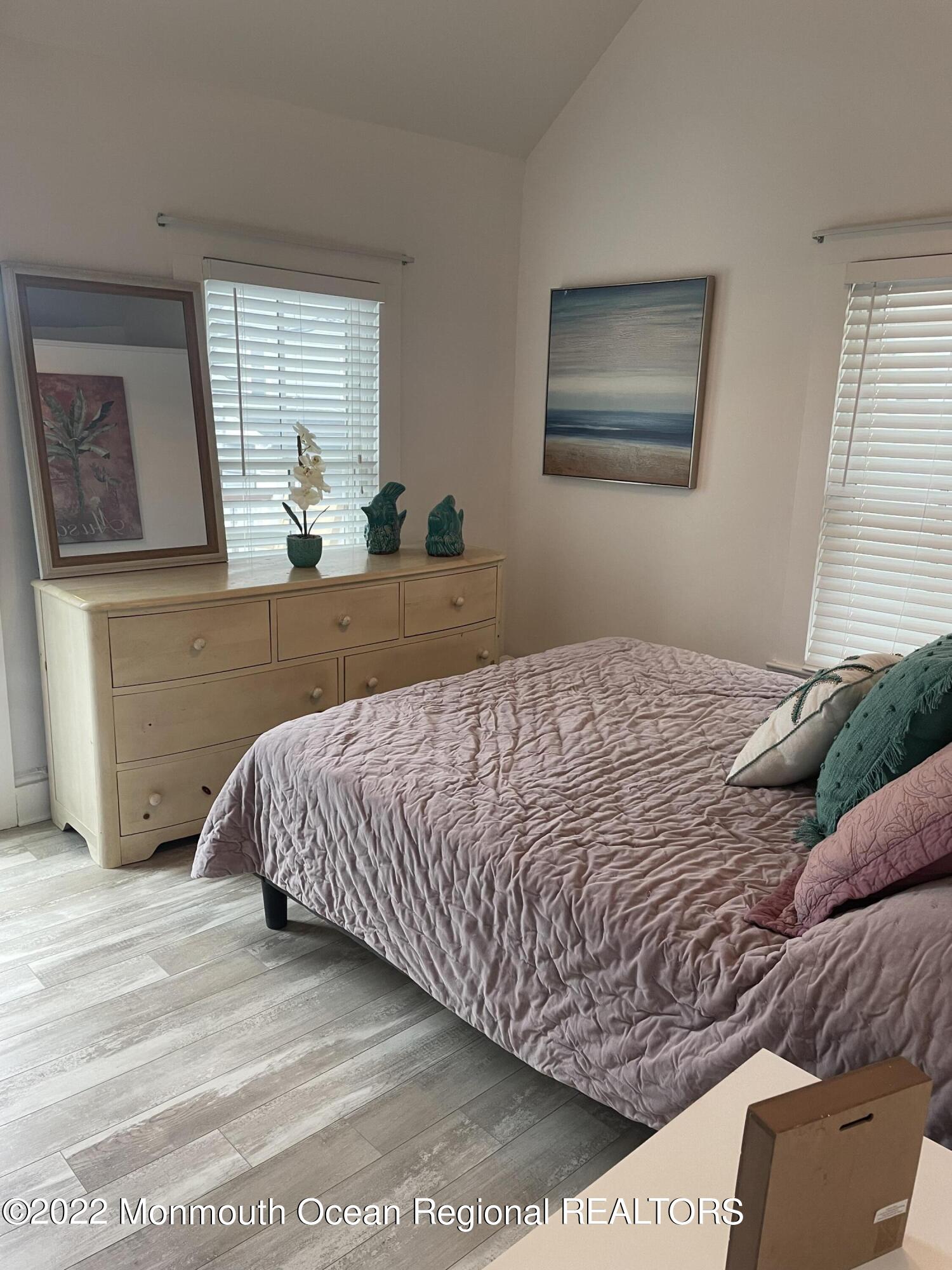 143 Mt Hermon Way, Unit 1/2 Ocean Grove, NJ 07756 - Photo 18 of 26 a bedroom with a bed and window