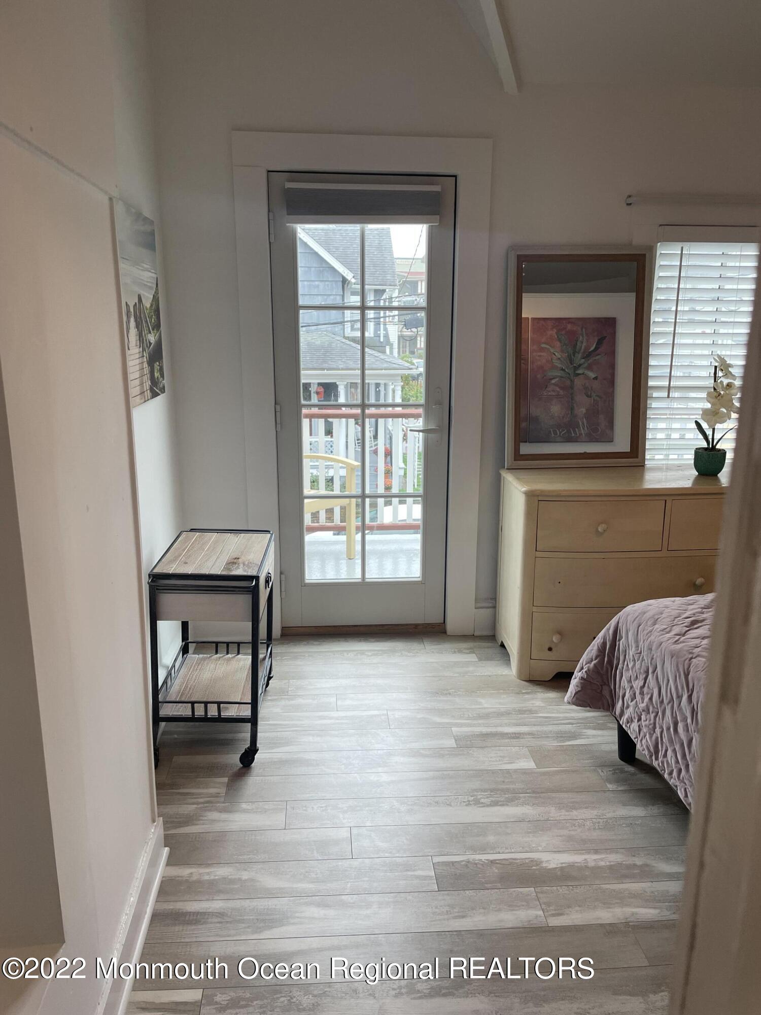 143 Mt Hermon Way, Unit 1/2 Ocean Grove, NJ 07756 - Photo 20 of 26 a bedroom with a bed and a window