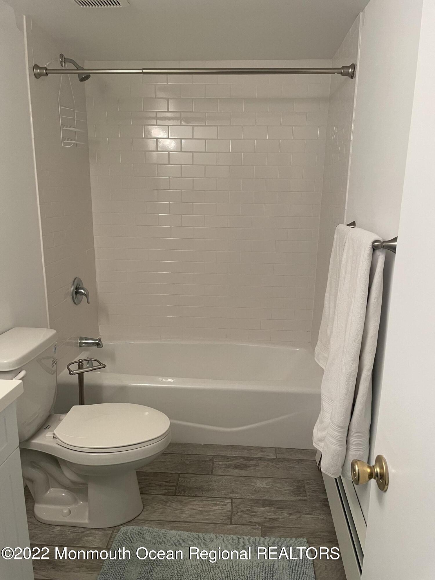 143 Mt Hermon Way, Unit 1/2 Ocean Grove, NJ 07756 - Photo 23 of 26 a bathroom with a toilet and a shower