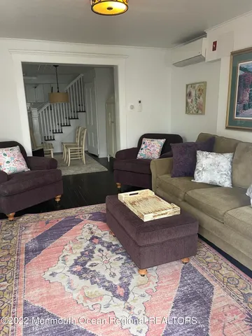 a living room with furniture and a rug
