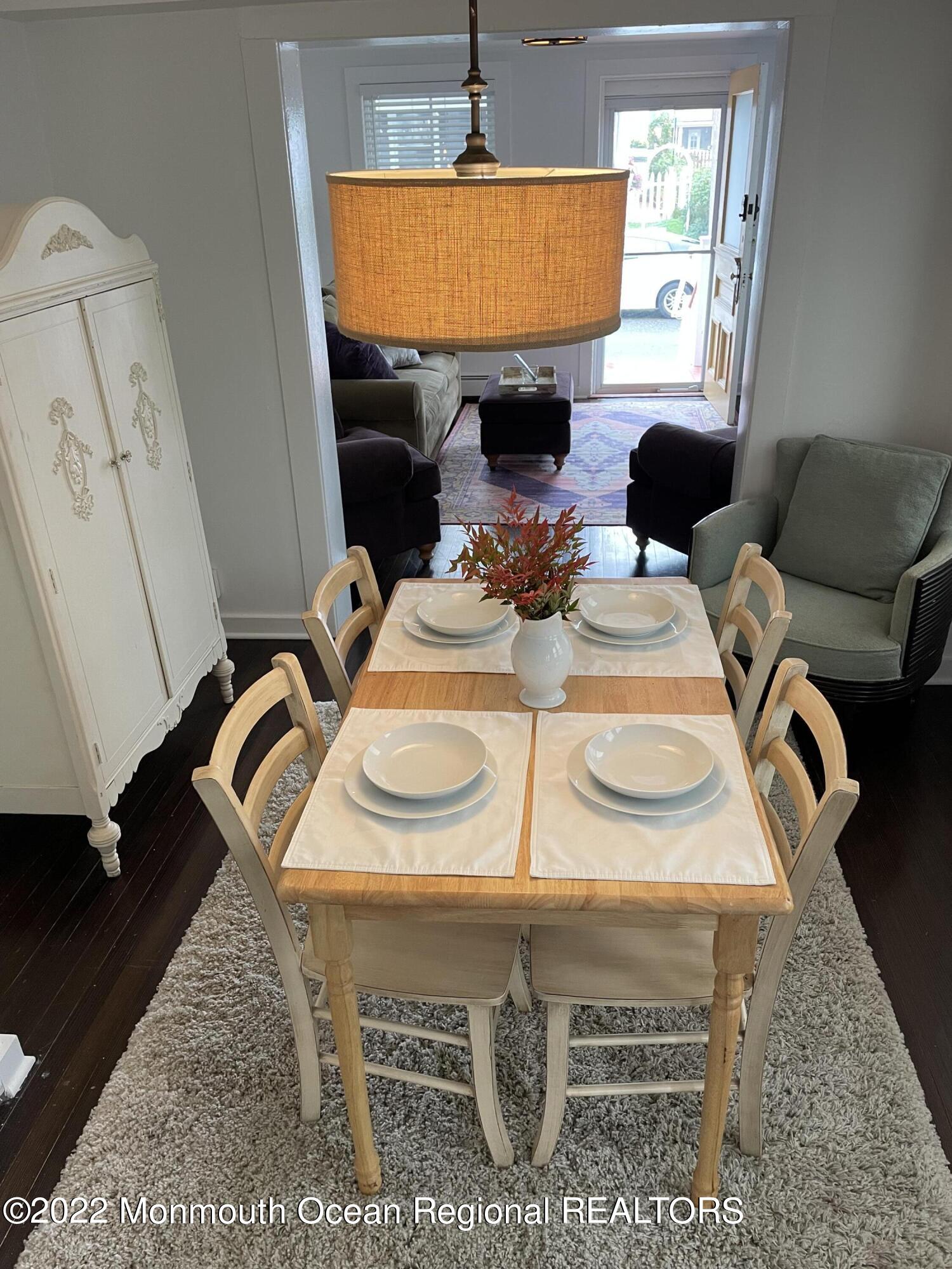 143 Mt Hermon Way, Unit 1/2 Ocean Grove, NJ 07756 - Photo 7 of 26 a dining room with furniture a rug and a window