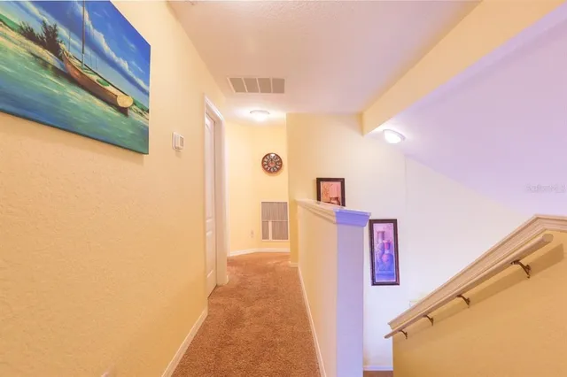 a bedroom with two beds and a chandelier