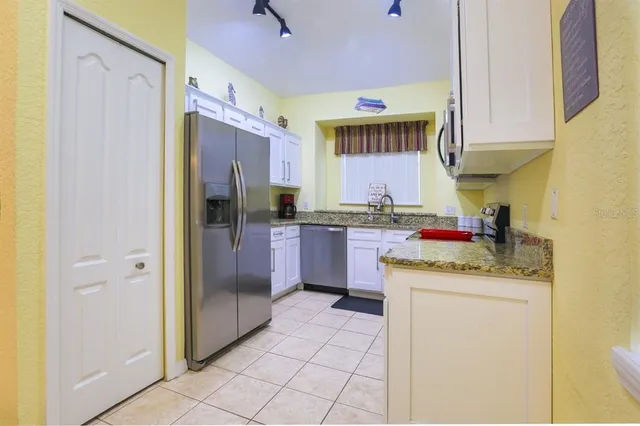 a kitchen with stainless steel appliances granite countertop a sink and cabinets