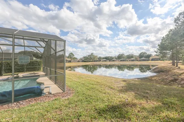 a view of a house with pool and ocean view