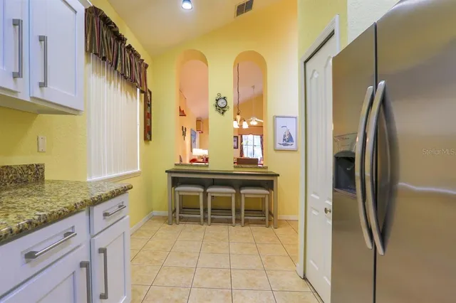 a kitchen with stainless steel appliances granite countertop a refrigerator and a sink
