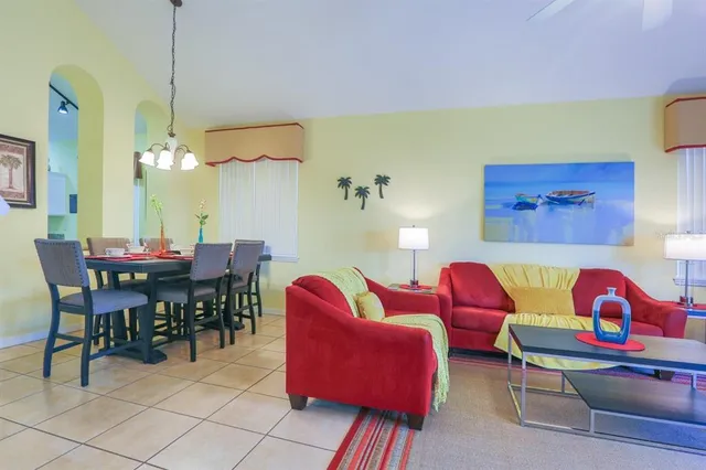 a view of a dining room with furniture and chandelier