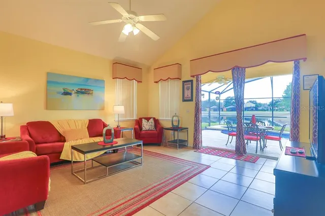 a living room with furniture and a floor to ceiling window