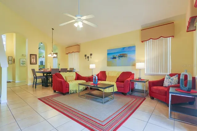 a living room with furniture a rug and a chandelier