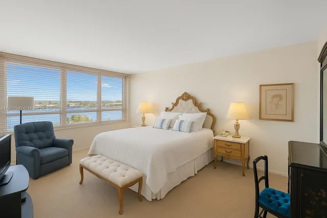 a bedroom with a bed and a large window