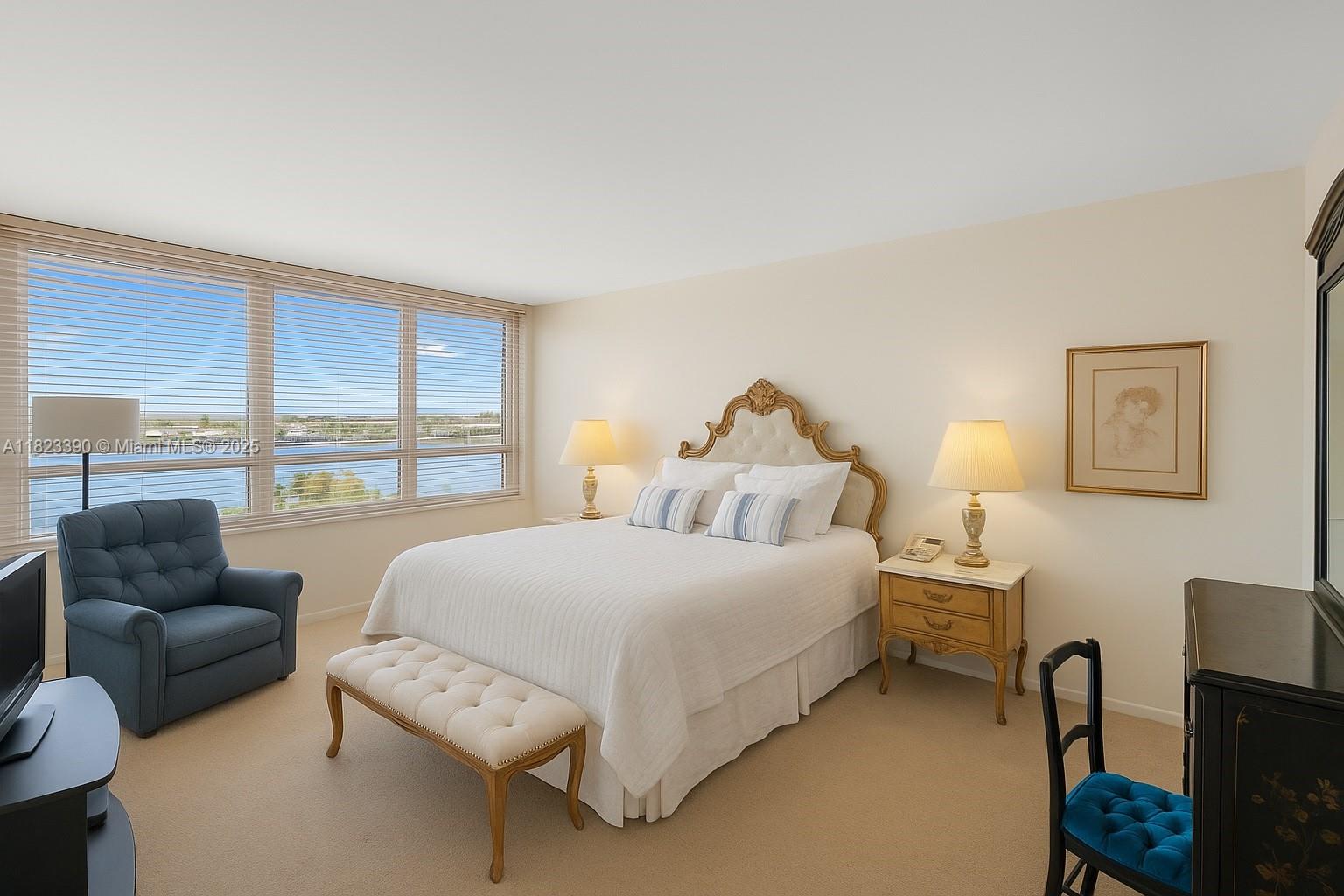 3 Grove Isle Drive, Unit C706 Miami, FL 33133 - Photo 17 of 20 a bedroom with a bed and a large window