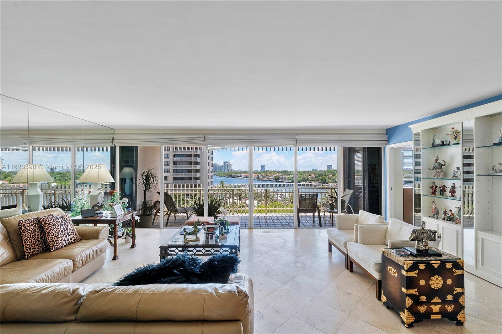 3 Grove Isle Drive, Unit C706 Miami, FL 33133 - Photo 2 of 20 a living room with furniture and a large window