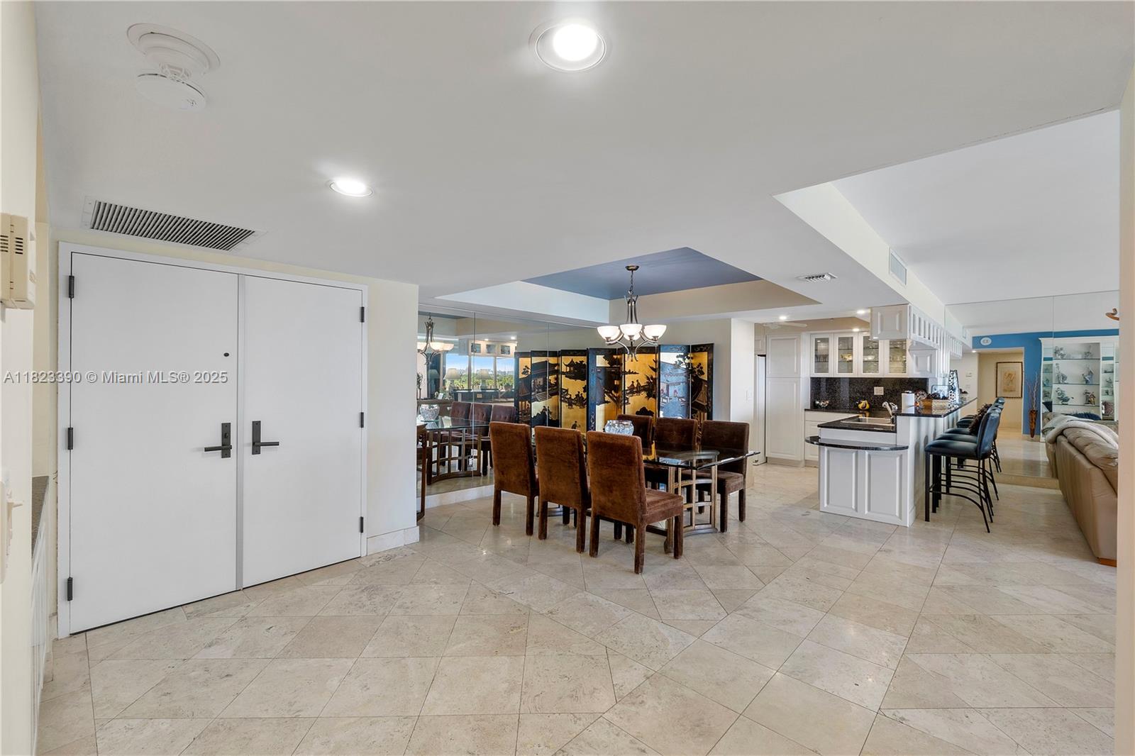 3 Grove Isle Drive, Unit C706 Miami, FL 33133 - Photo 3 of 20 a view of a dining area with furniture and chandelier