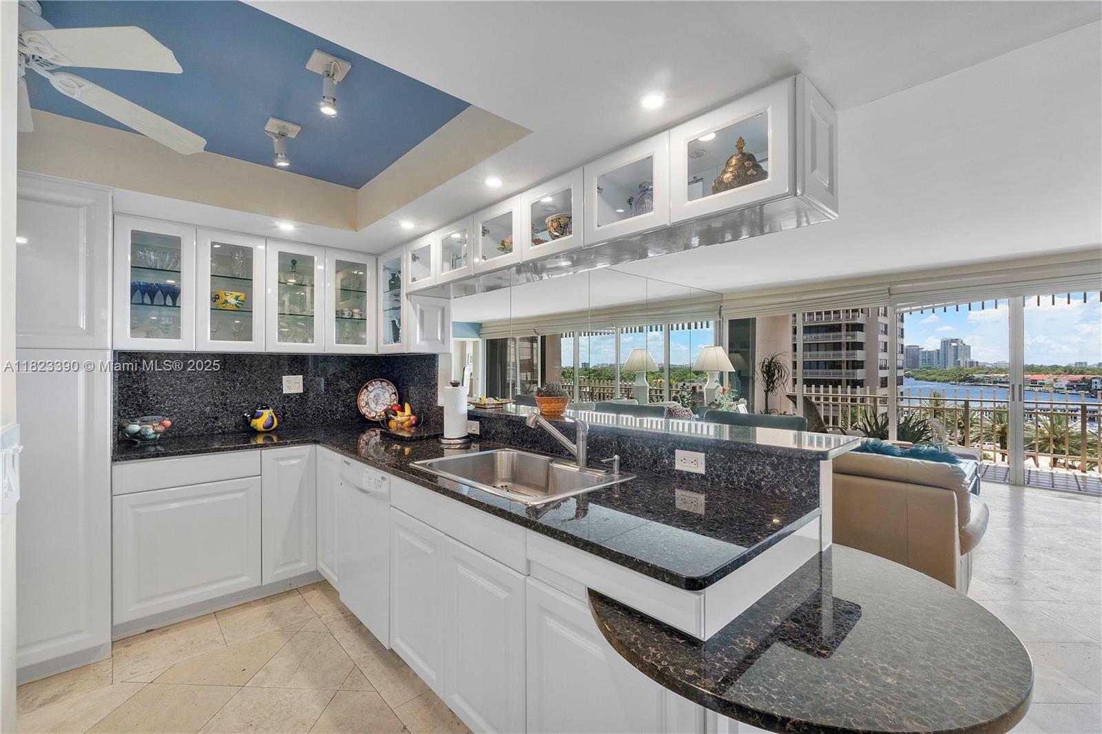 3 Grove Isle Drive, Unit C706 Miami, FL 33133 - Photo 4 of 20 a kitchen with stainless steel appliances granite countertop a sink and a counter space