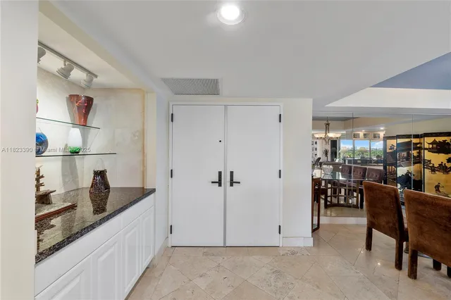 a kitchen with granite countertop cabinets and chairs