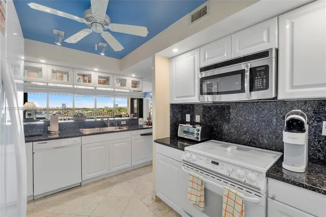a kitchen with stainless steel appliances granite countertop a sink and cabinets